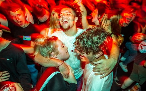 Clubbers inside FAC 51 nightclub in Manchester City Centre after midnight and so-called freedom day, when regulations on wearing of masks, social distancing and other measures designed to prevent the spread of Coronavirus in England are relaxed