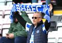 Brighton fans put on a brave face as they watch their side lose 3-0 to Bournemouth