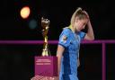 Keira Walsh walks by the Women's World Cup trophy following England's loss in the final to Spain