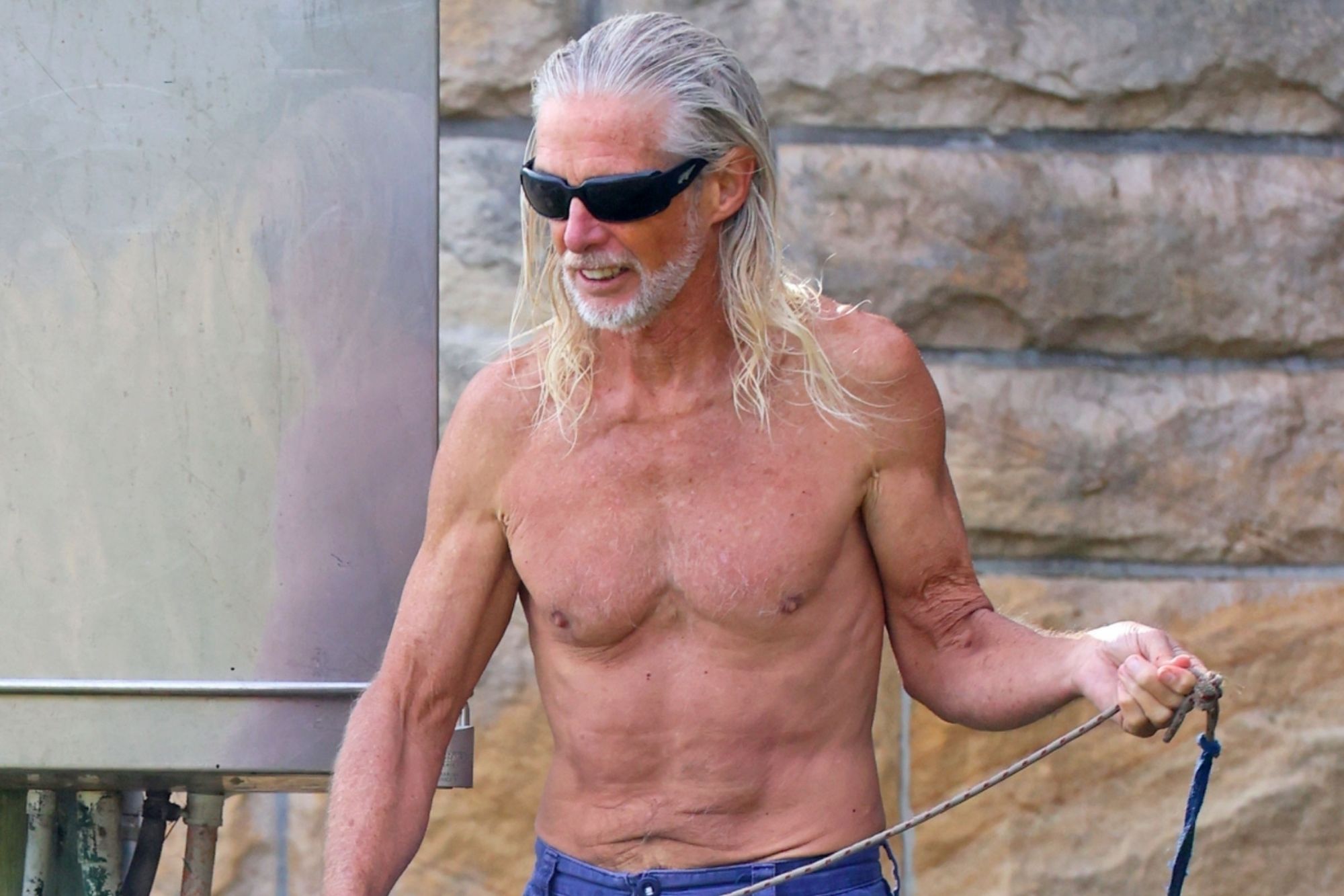Eighties movie star, 70, unrecognisable as he strips topless on beach