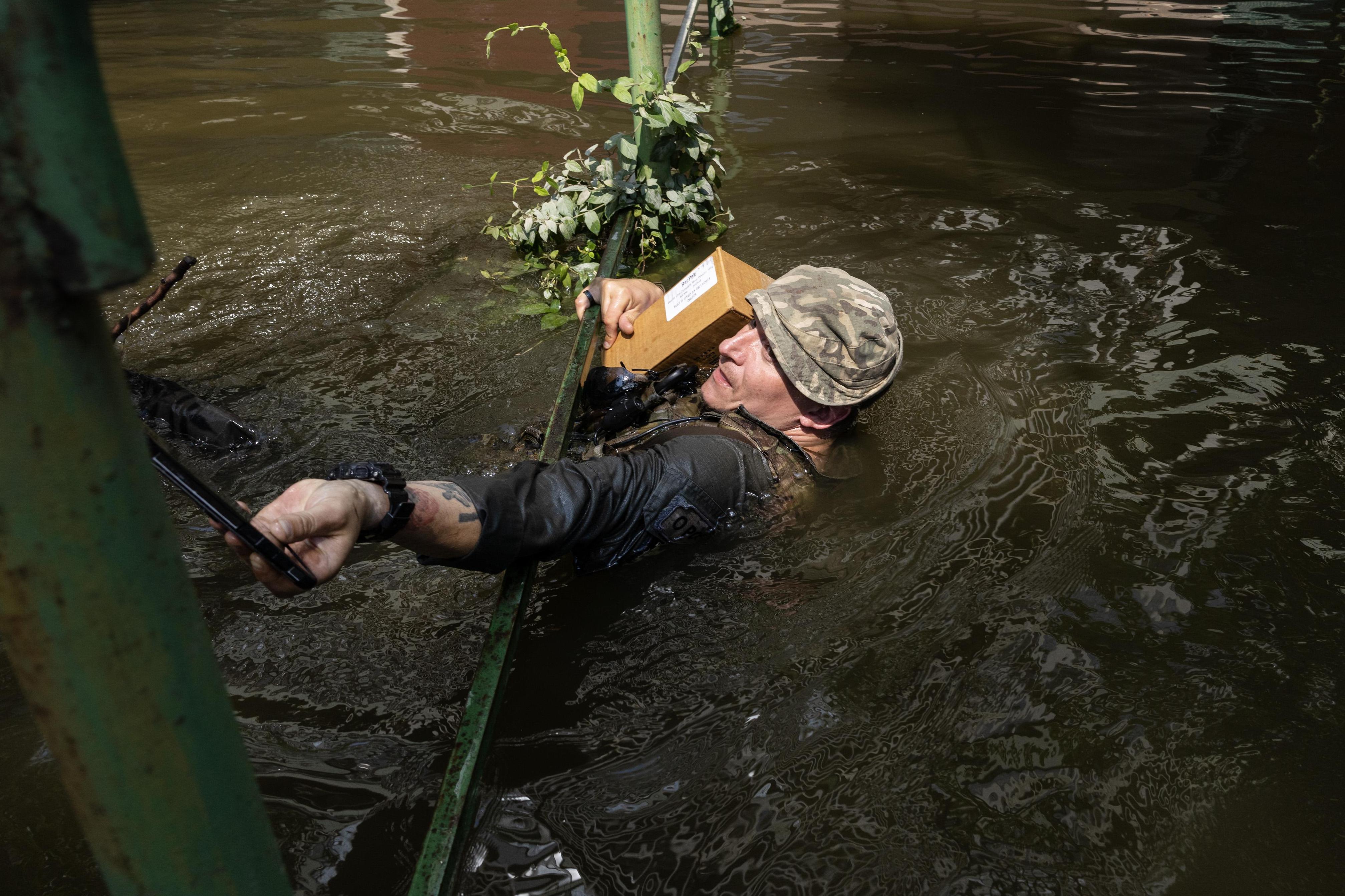 Flood helpers throw themselves to the ground as Putin’s shells land by the rescue point
