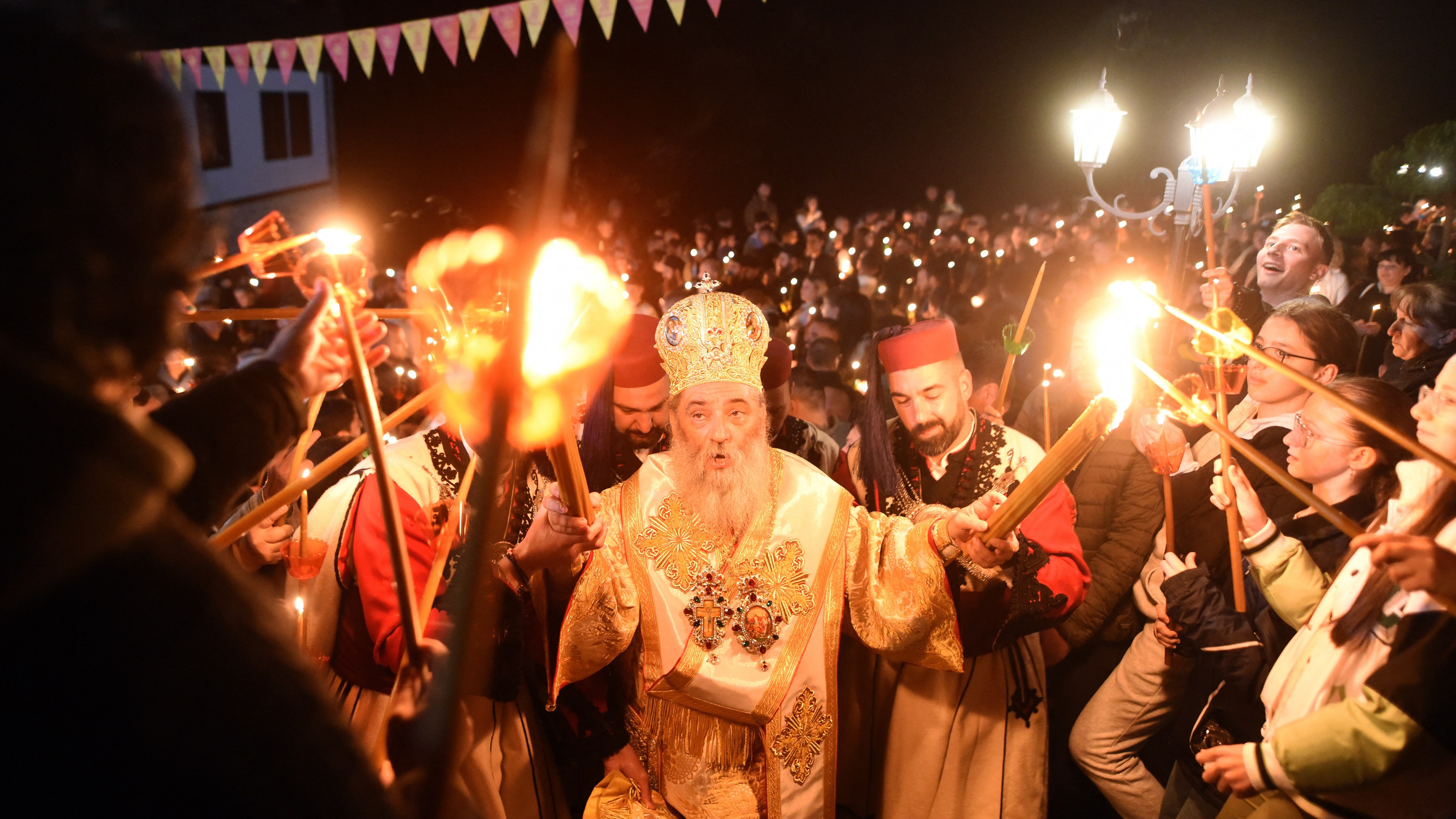 Macedonian Orthodox Christians light candles from the holy fire that arrived from Jerusalem during an Easter service at the Saint Jovan Bigorski monastery in Mavrovo