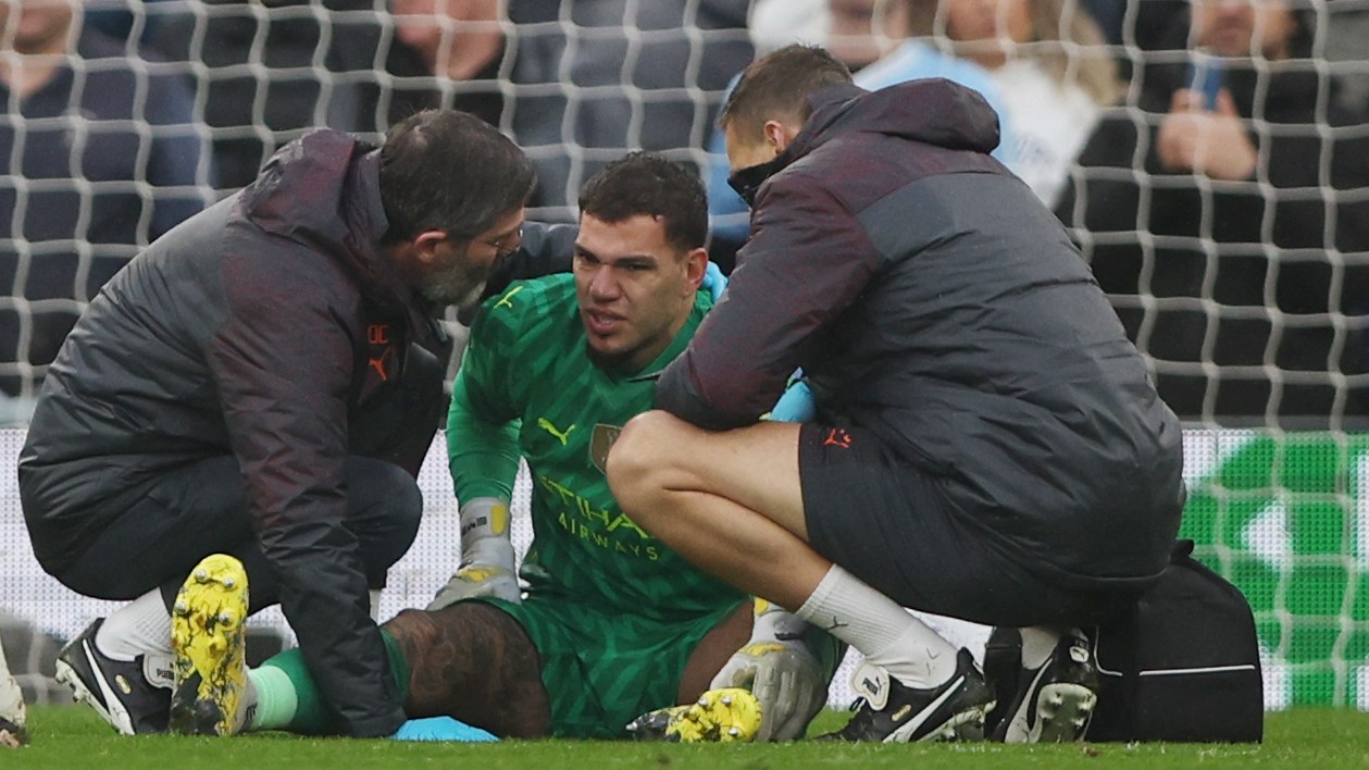 Ederson receives treatment before having to leave the field with a thigh injury at Anfield on March 10
