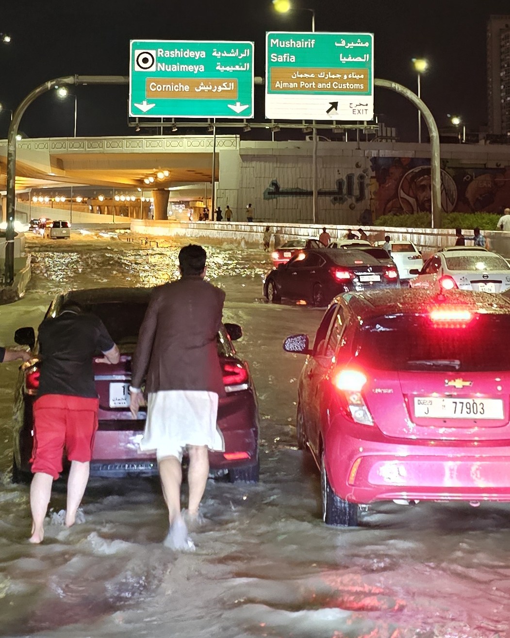 Residents of Dubai had to push their cars to safety through high water on Tuesday night