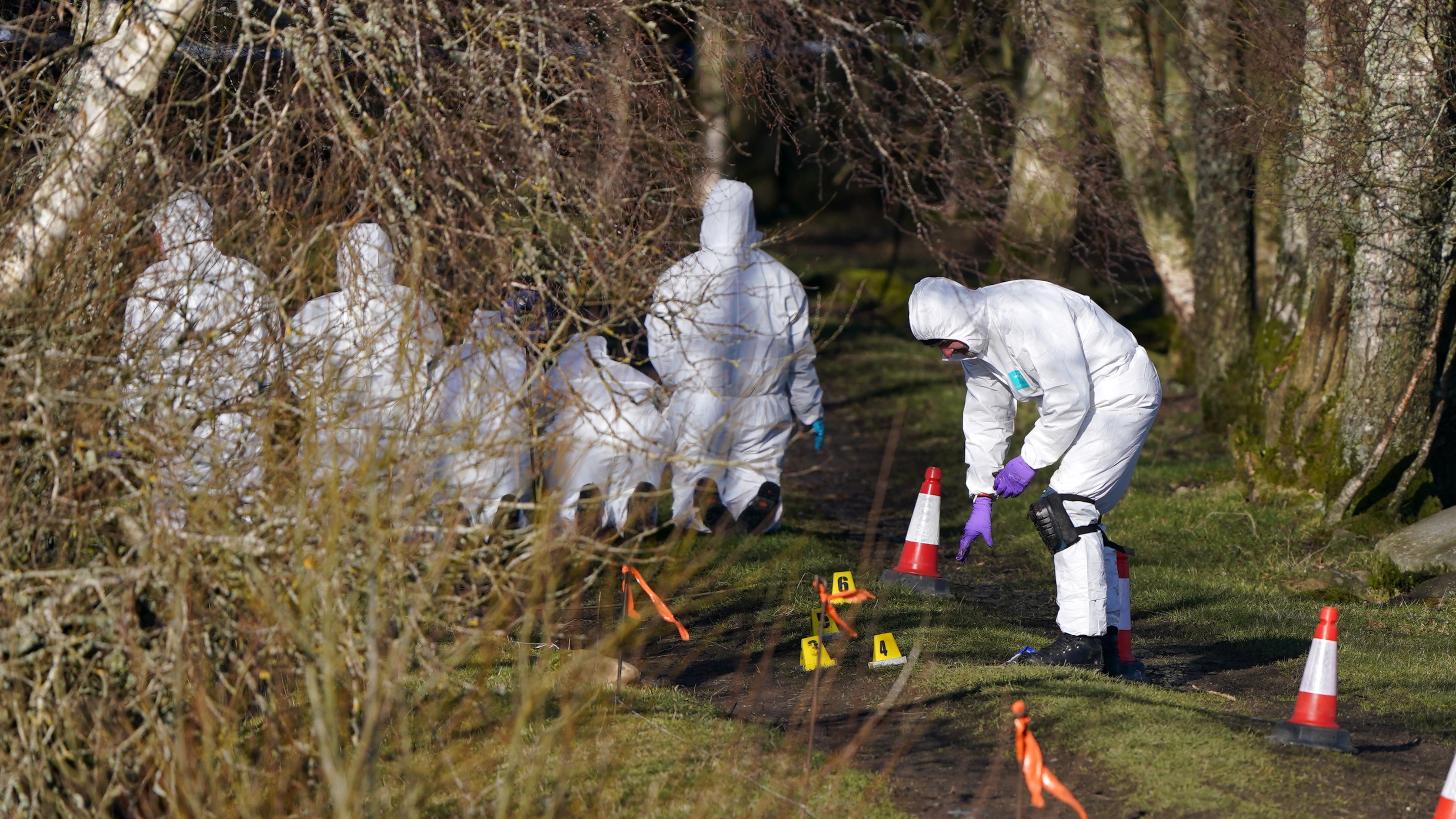 Forensics experts examined the scene of the shooting near the hamlet of Pitilie