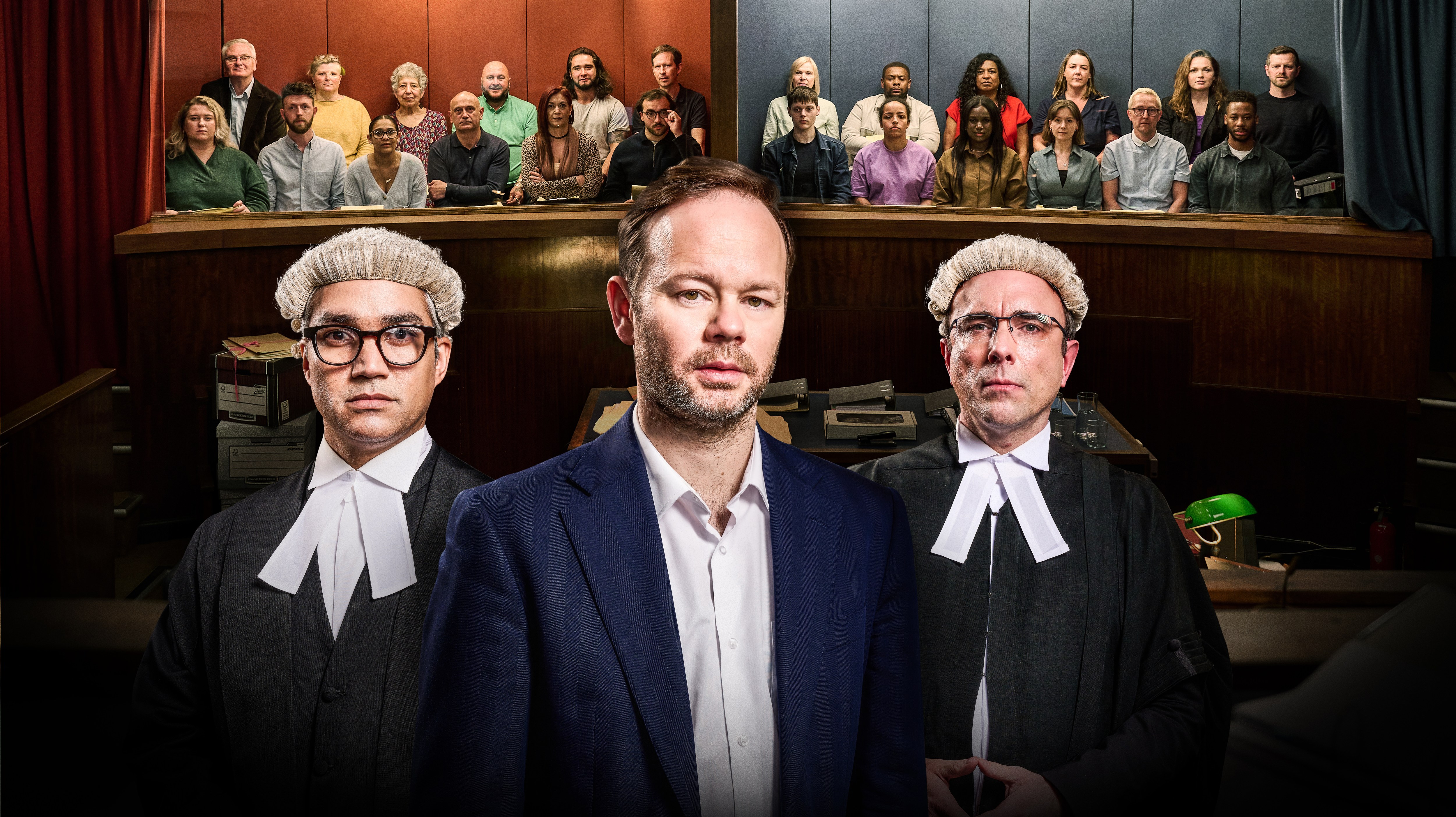 RED JURY – Top Row L-R: Gary, Victoria, Diana, Ricky, Chris, Neil. Bottom row L-R: Rosie, Richard, Kelly, Keith, Emily, Luca. BLUE JURY – Top Row L-R: Hilary, Aaron, Sonia, Jodie, Liberty, Adam. Bottom row L-R: Ollie, Sacha, Lorell, Emily, William, Junior.  Front of image L-R: Defence Barrister – Xavier Ahmad QC (Christopher Simpson) Defendant – John Risedale (Sam Alexander) Prosecution – Mr Ryan Thomas (Andrew Piper) in The Jury – Murder Trial