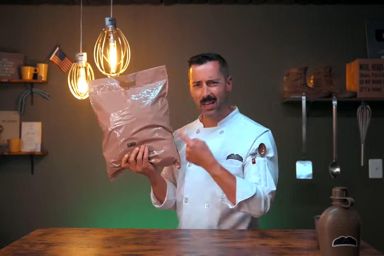 a man in a chef 's uniform holds a bag of food