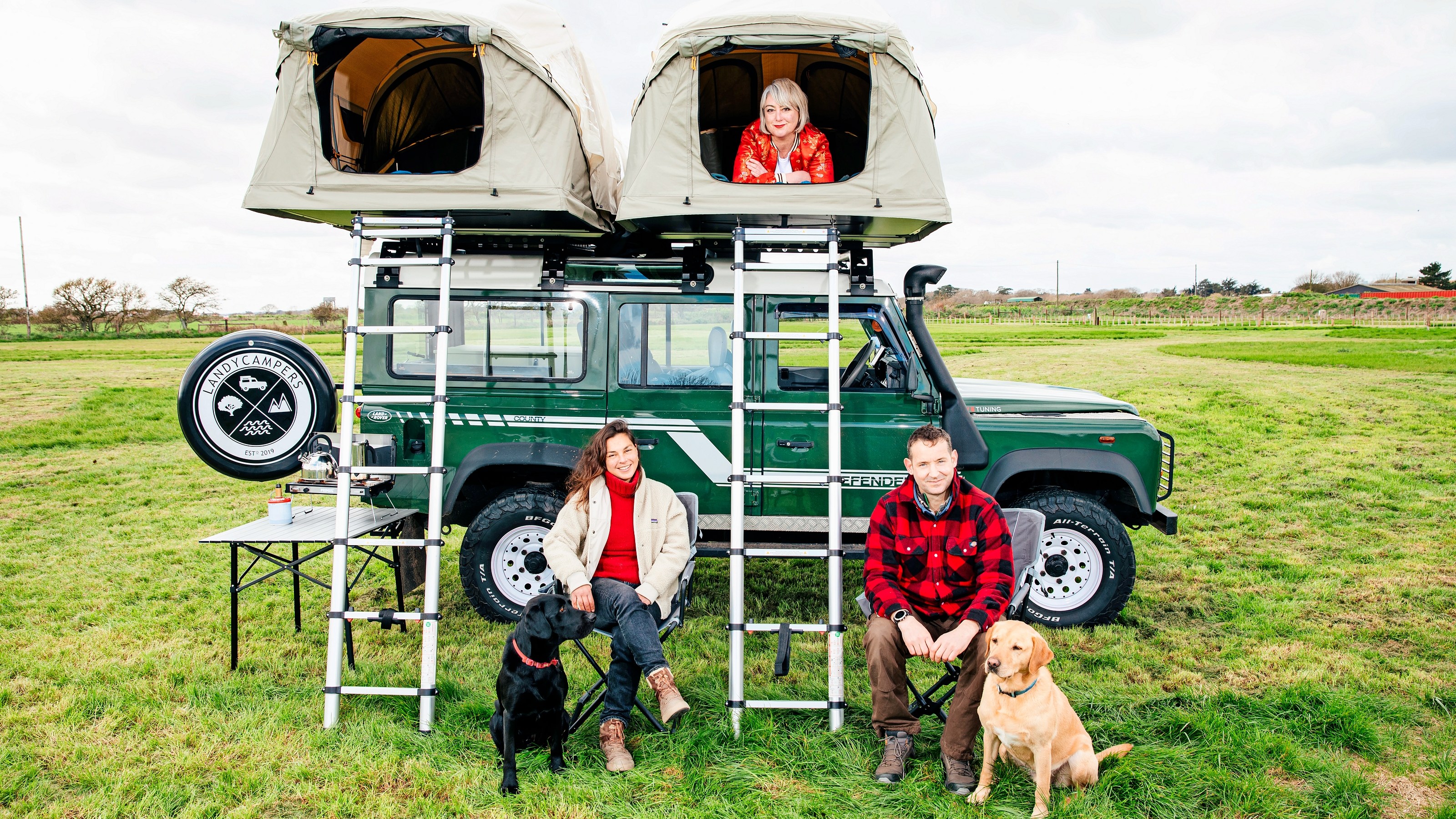 Jane Mulkerrins, Rebecca and Ed Owen, and their dogs Rosco and Bo, camping in Suffolk in a converted Land Rover