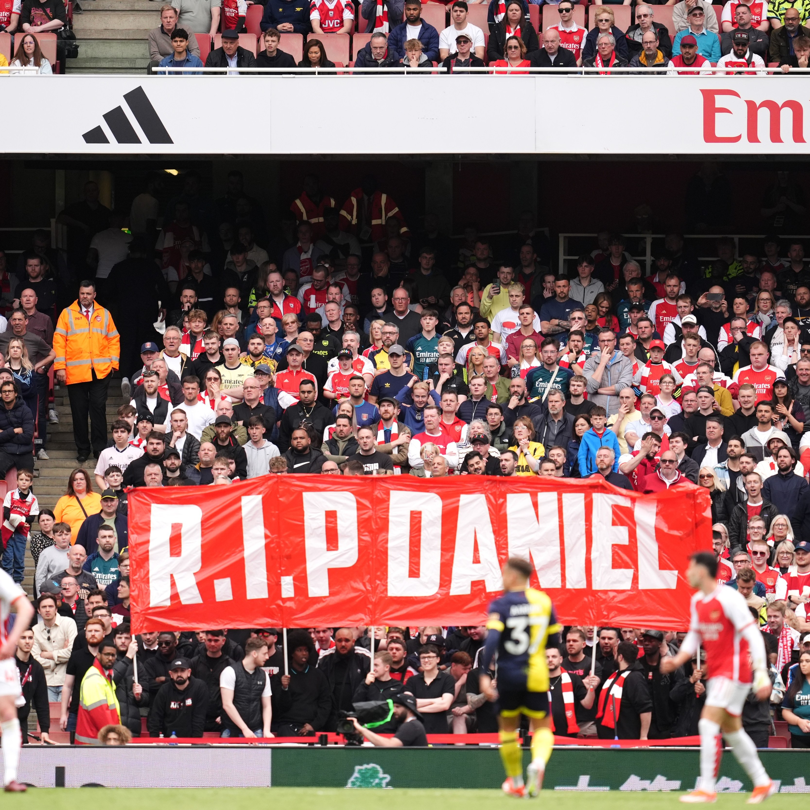 Fans hold up a banner in memory of Daniel Anjorin during the Premier League match at the Emirates Stadium