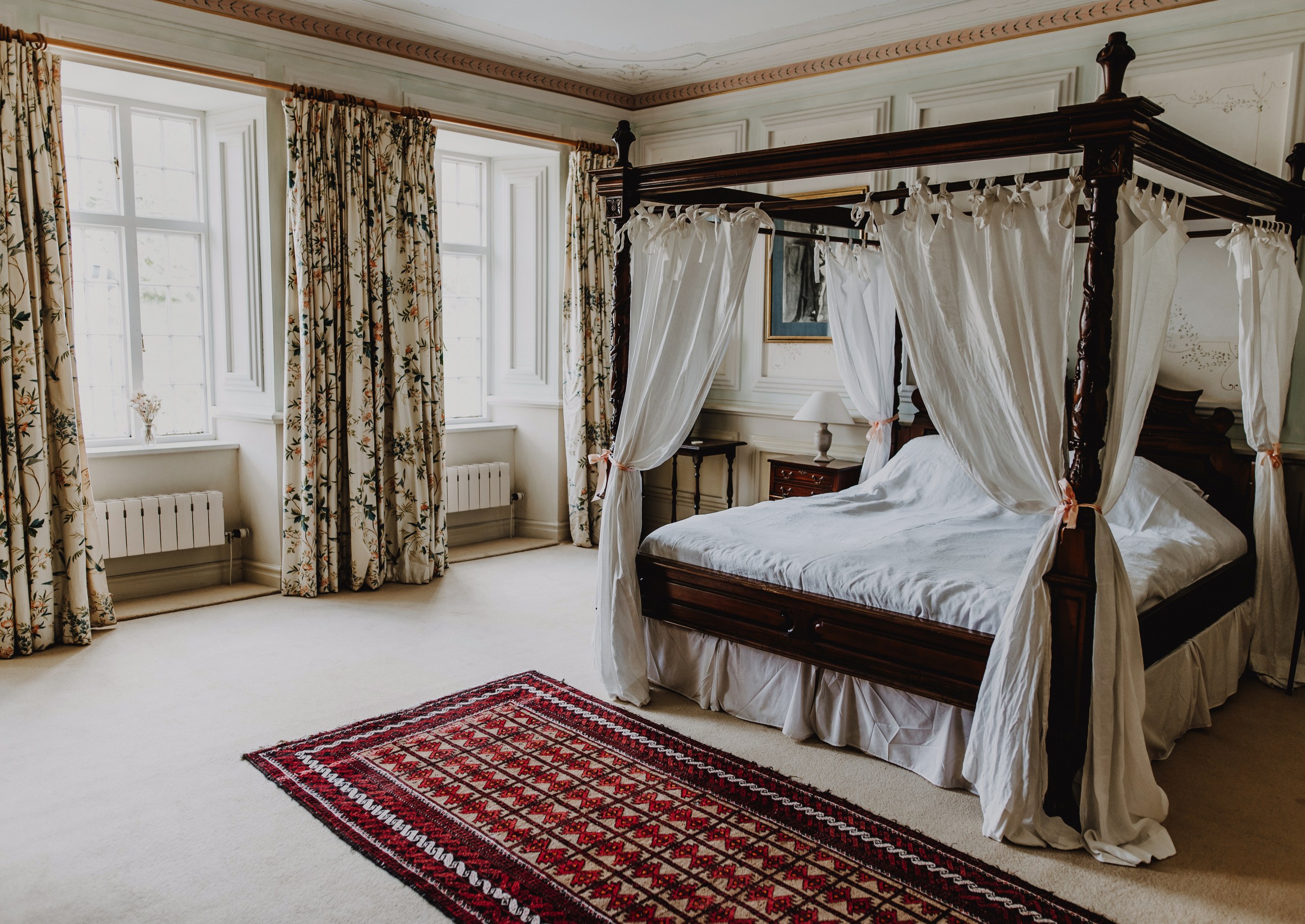 The bridal suite at Ashlack Hall features wood panelling and a four-poster bed