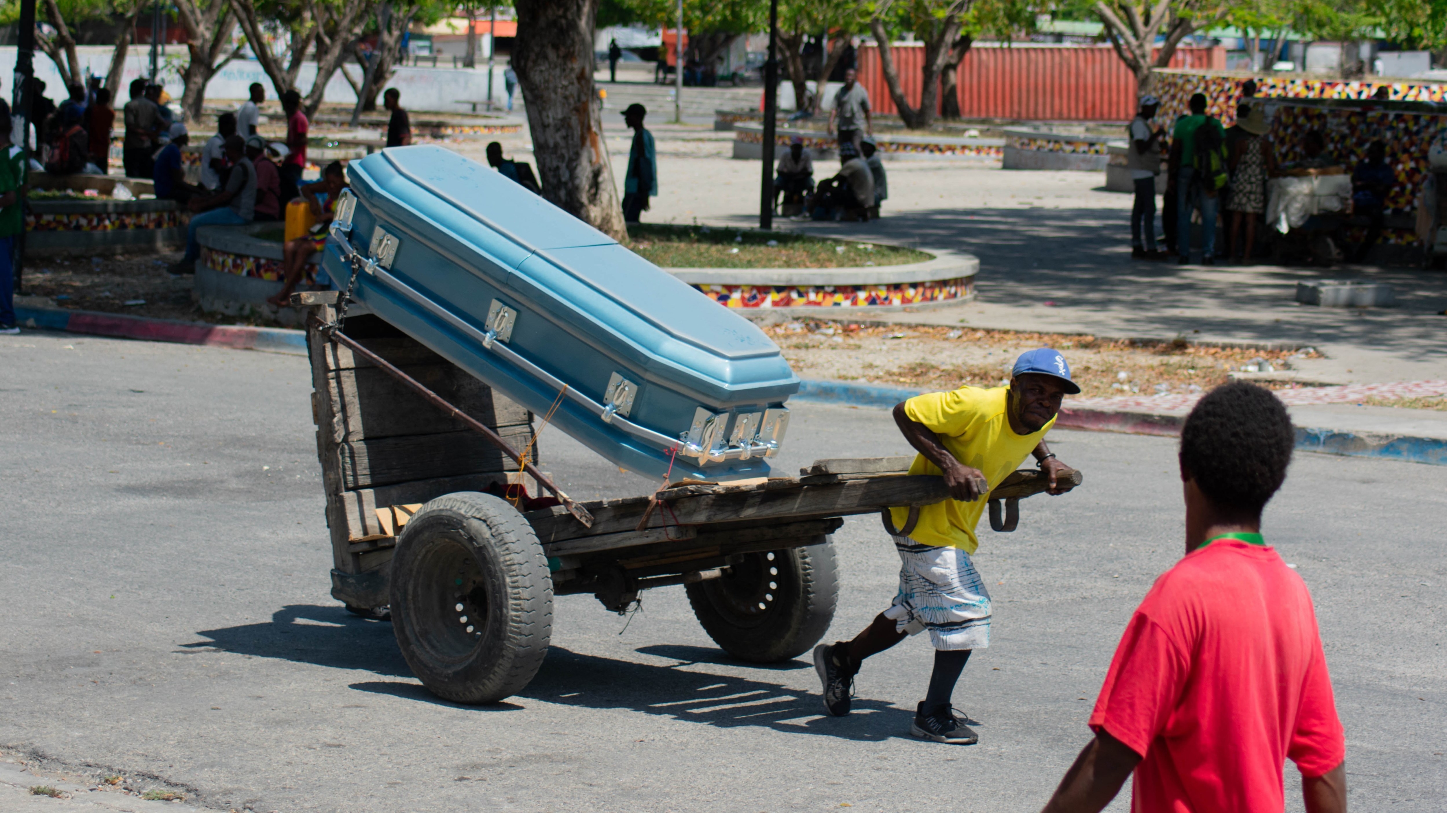 A coffin is pulled through Port-au-Prince, the capital, where violence continues to hobble society and the state