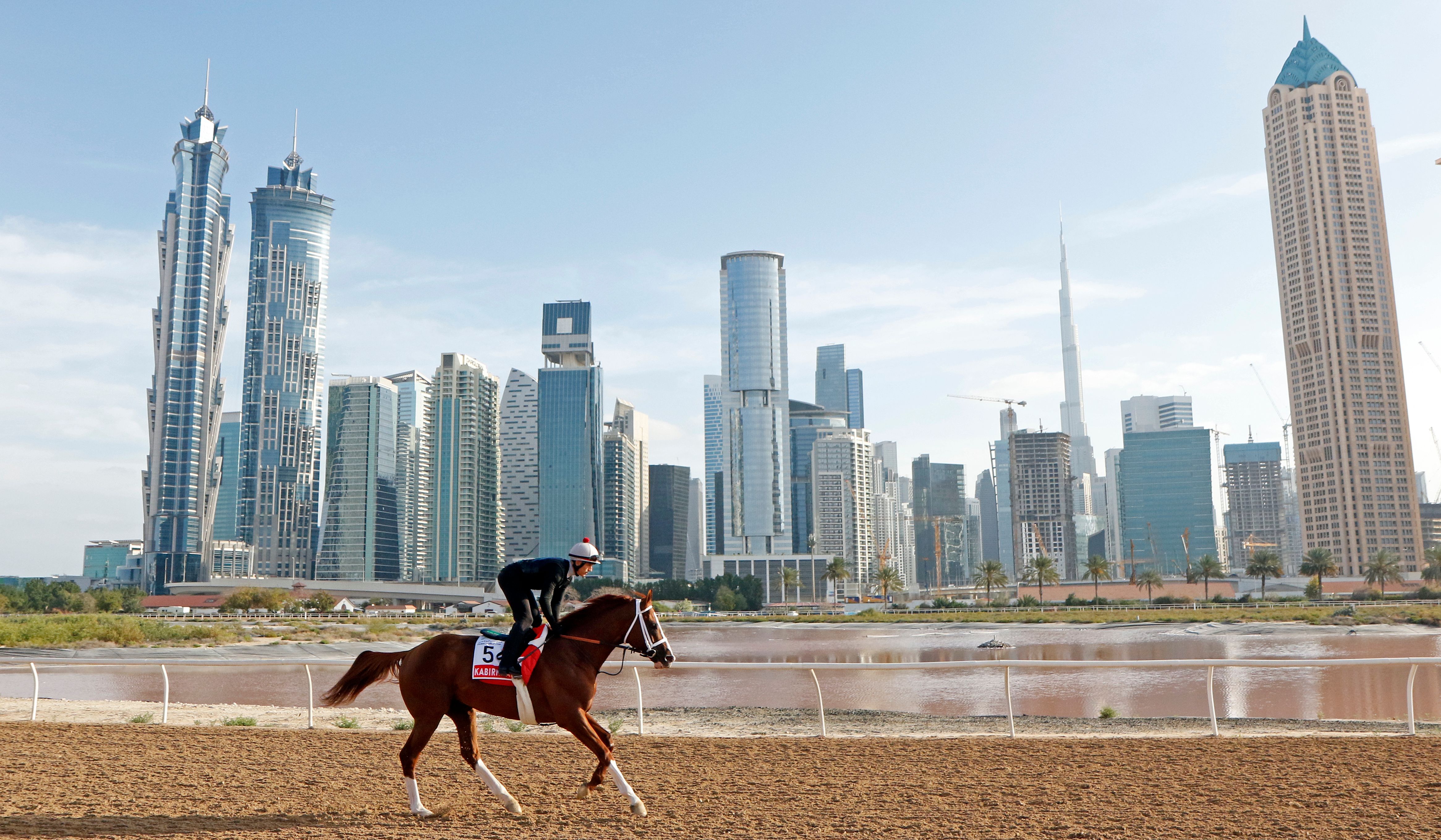 A jockey takes Kabirkhan, a rising star, along the Al Quoz training track to prepare for the Dubai World Cup on Saturday