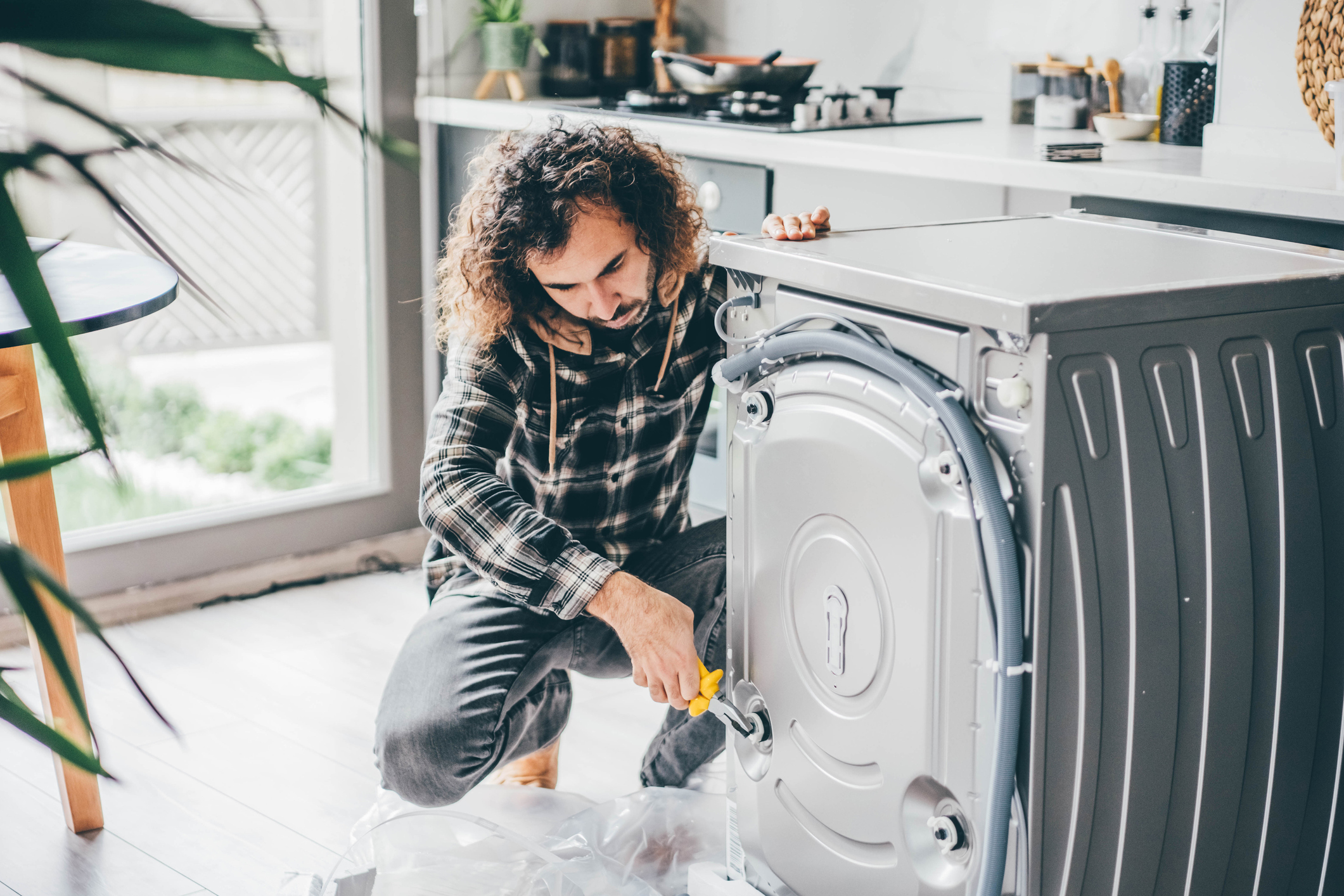 Man fixing washing machine, use Domestic & General