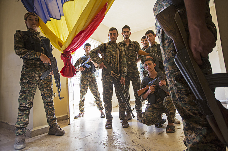 Commander Matay surrounded by members of the Syriac Military Council