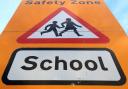 A stock image of a school road sign