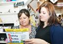 Gazette reporter Anna Clarke hands a copy of the poster to Elizabeth McGonagle at The Little Shop, Arnside