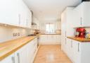 The light-filled kitchen has cream units topped with wooden work surfaces