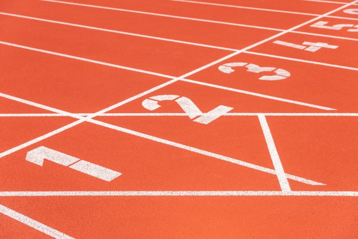 Close up photograph of the start line of an athletics track