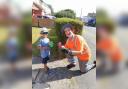 Four year old Lucas Edge serving drinks to workers in the scorching weather.