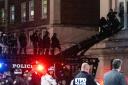 Hundreds of New York City police swept into Columbia University on Tuesday night to end a pro-Palestinian occupation of an administration building and sweep away a protest encampment (Craig Ruttle/AP)