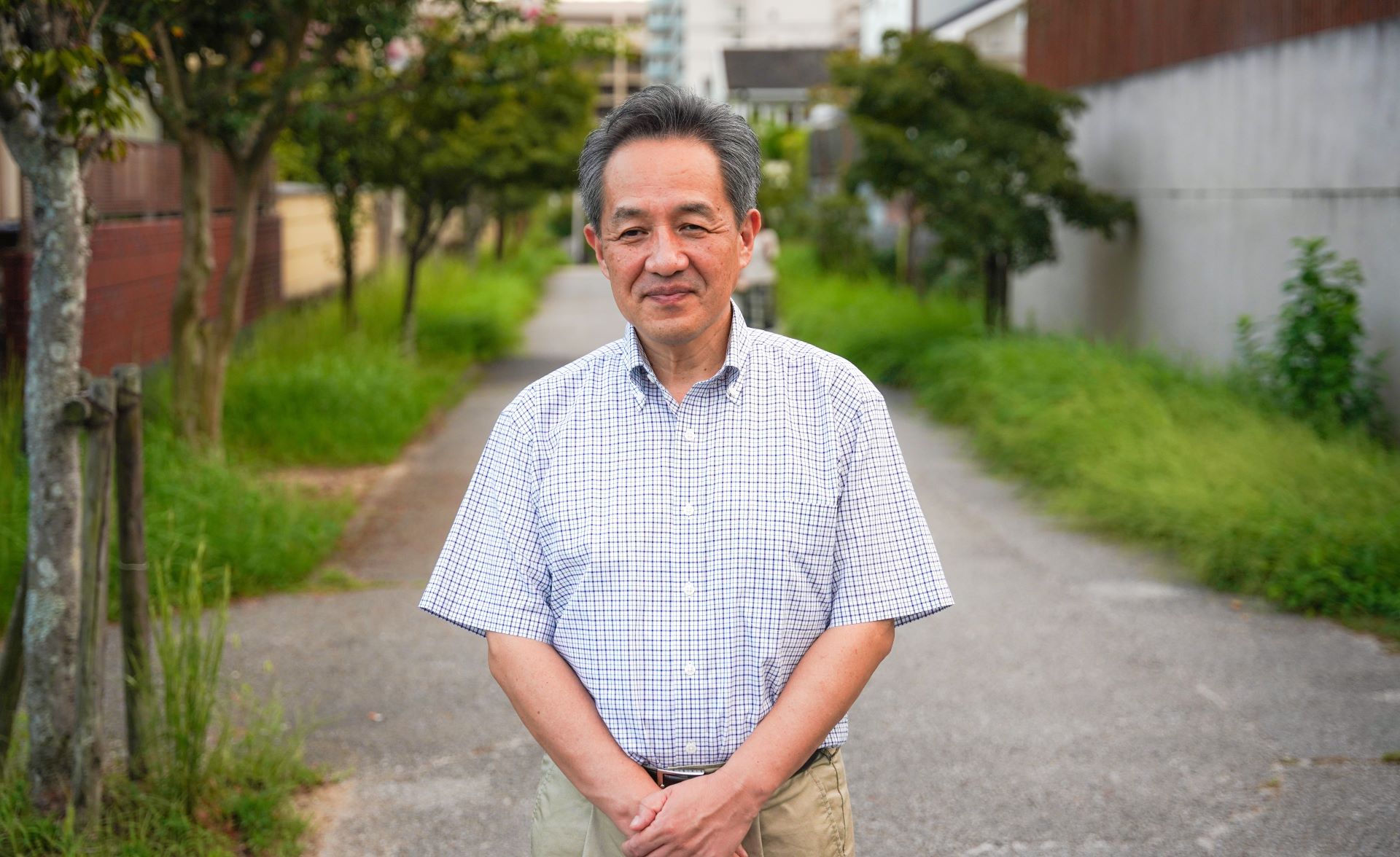 Mr Katsumura Hisashi stand outside near where he lives in Japan