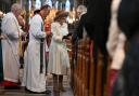 GIFT: Queen Camilla, deputising for the King, distributes the Maundy money - newly minted coins - to community stalwarts in recognition of their service, during the Royal Maundy Service at Worcester Cathedral.