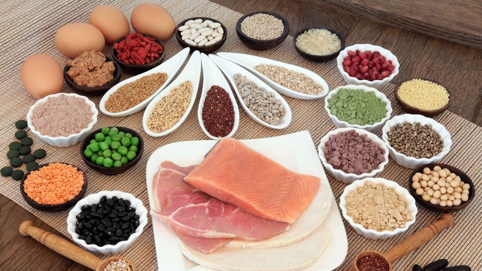 Protein-rich foods including eggs, meat, fish and pulses on a table (Credit: Getty Images)