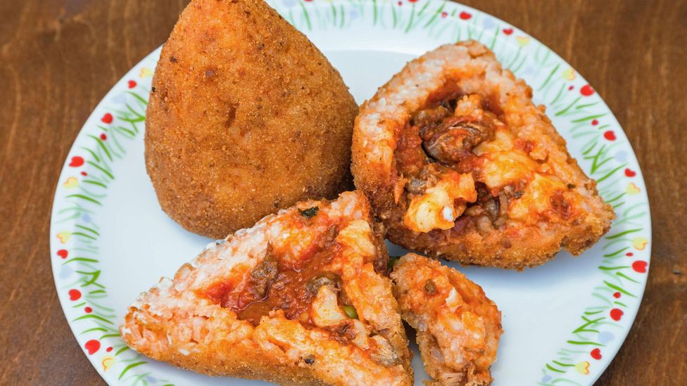 Arancini, or arancine, are deep-fried rice balls stuffed with savoury ingredients like green peas and meat (Credit: Valery Voennyy/Alamy)