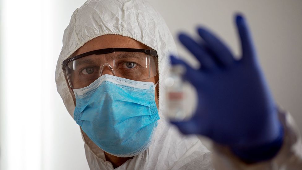 A scientist holding up a vial of Covid-19 vaccine (Credit: Getty Images)