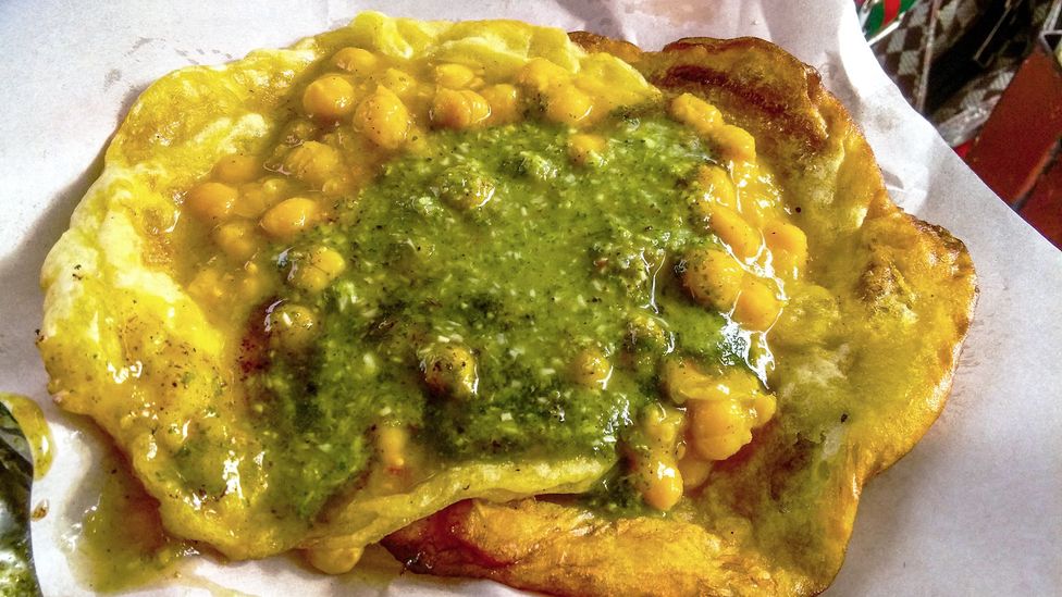 Doubles is a sandwich made from curried chickpeas tucked between two pieces of fried flat bread (Credit: Barry Ramkissoon/Getty Images)