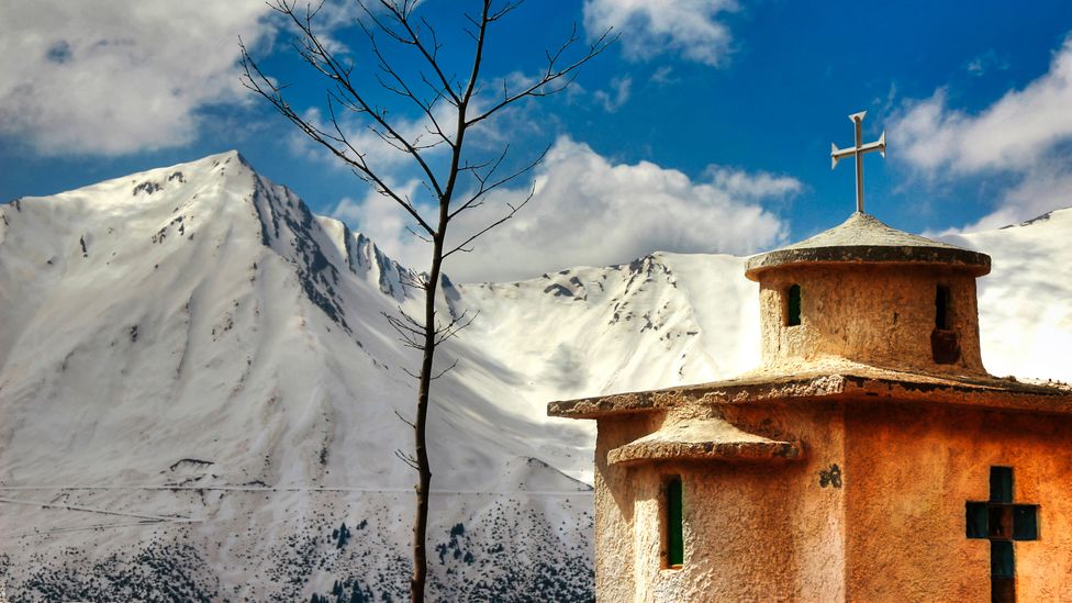 Church and snowy mountain view at Agrafa, Greece