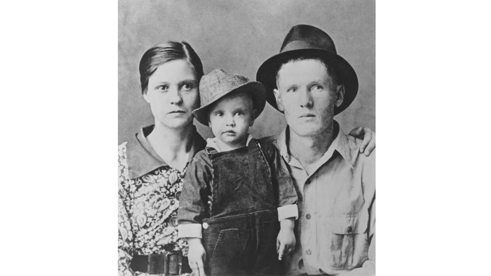 Elvis, pictured here with his parents in 1937, grew up in a majority black neighbourhood in Tupelo, Mississippi (Credit: Getty Images)