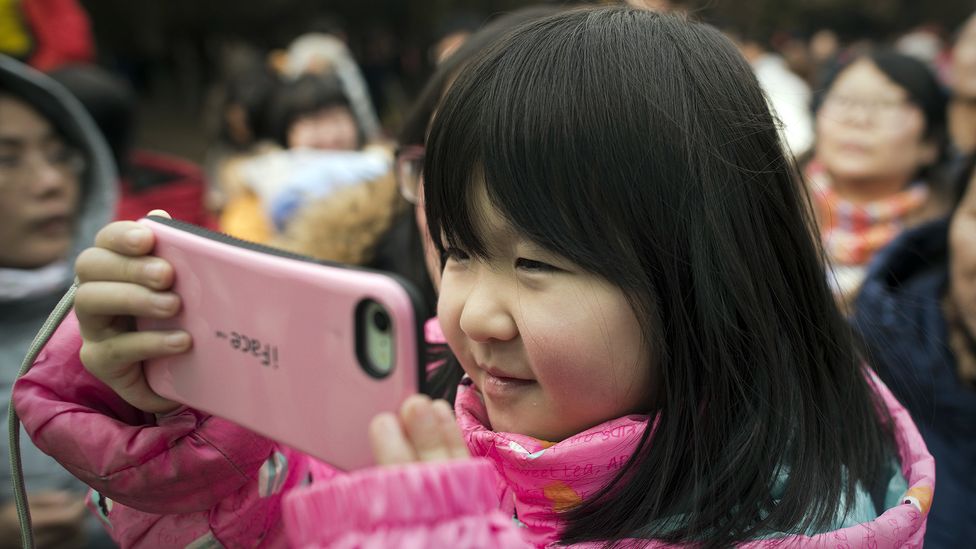 The evidence on when is the right time to give a child their own smartphone is poor, but there are key moments where the risks are higher (Credit: Nicolas Asouri/AFP/Getty Images)
