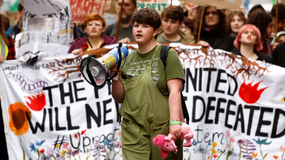 Protestors march in Glasgow in 2022 as part of Fridays For Future, the global climate strike movement started in 2018 by Greta Thunberg (Credit: Jeff J Mitchell/Getty Images)