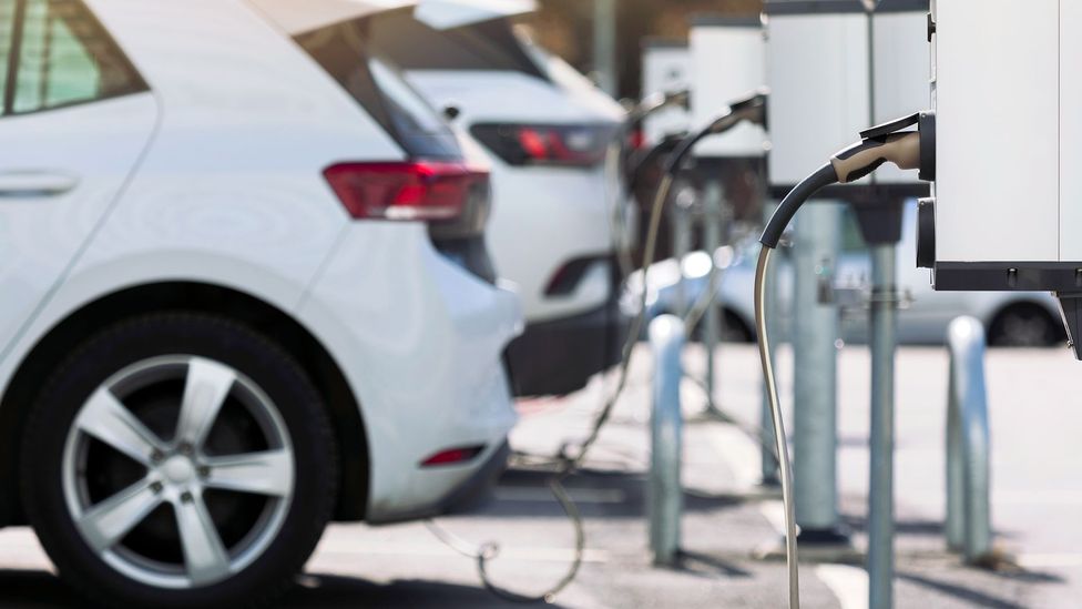 Electric vehicles charging in a car park (Credit: Getty Images)