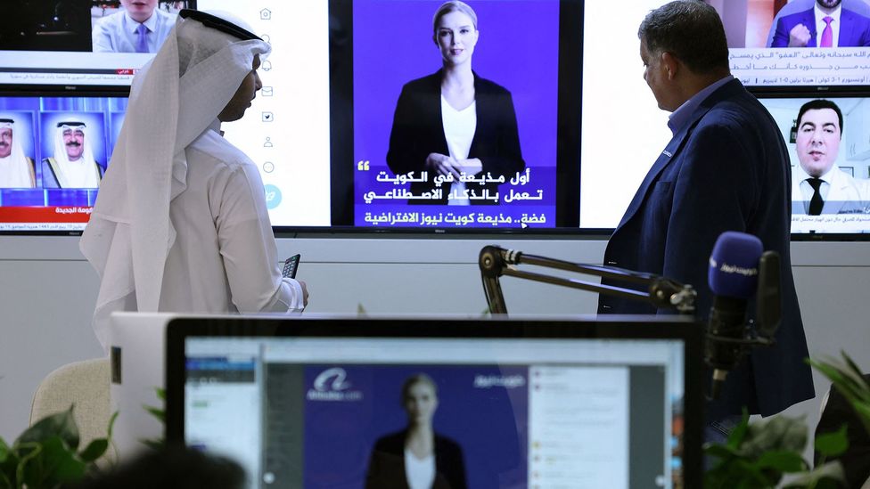 Journalists watch a video of Kuwait News service AI-anchor Fedha (Credit: Getty Images)