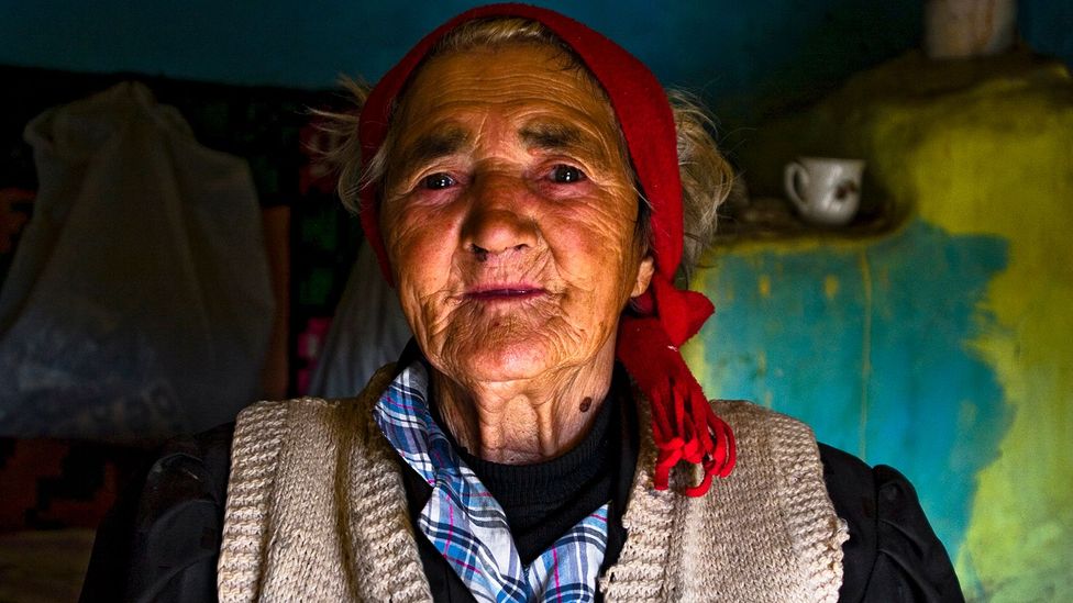 Old woman in rustic house in Romania